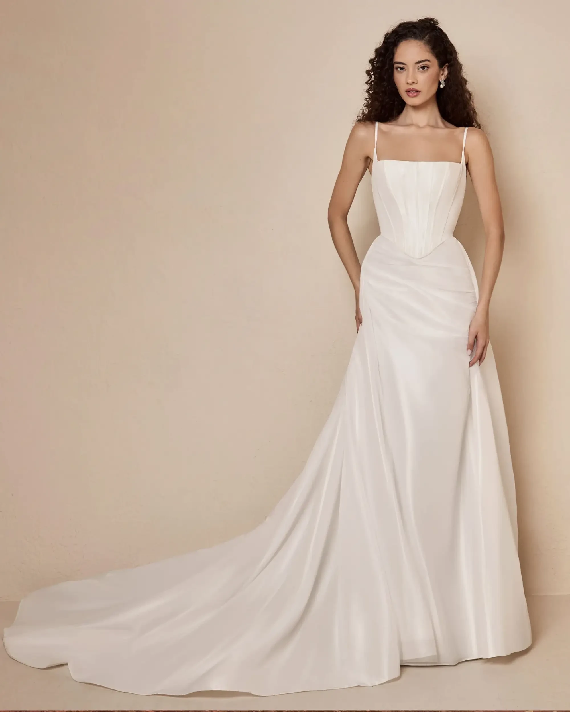 Model is wearing an a-line wedding dress with a square neckline